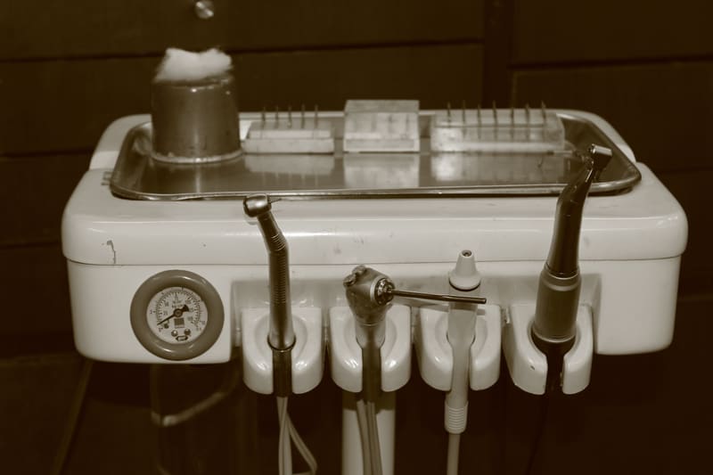 Modern dental treatment room with ergonomic chair and overhead examination light